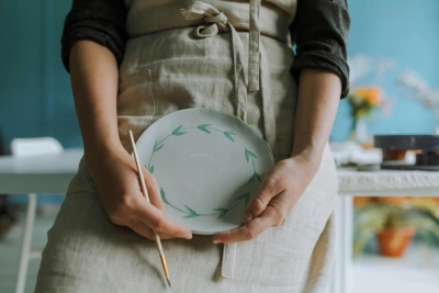 Woman showing painted plate